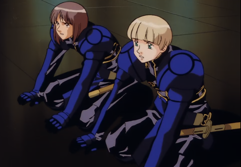screenshot of Dallet and Shesta kneeling on the floor, looking up towards where Dilandau stands off camera. they look like they're trying not to cry in front of everyone.